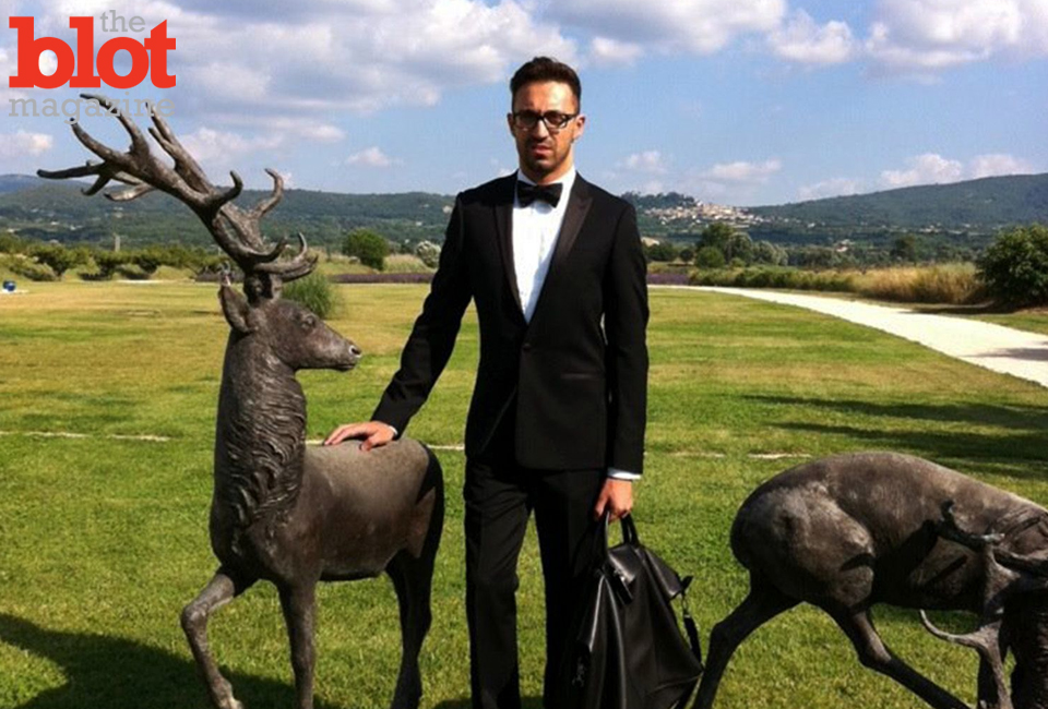 November Style Master Stephan Rabimov, wearing a Sandro tuxedo, Cole Haan shoes, Longchamp tote and Yohji Yamamoto glasses, at the Pierre Cardin chateau in Lacoste, France.